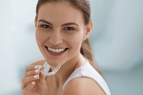 young women holding a invisalign